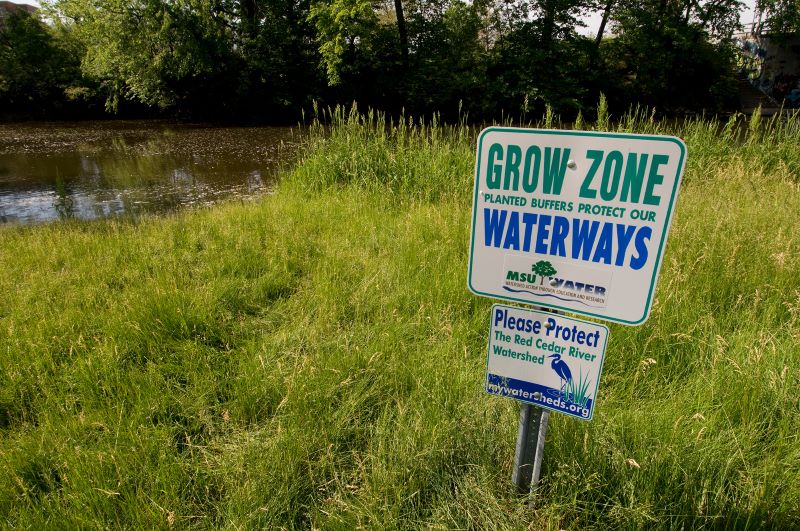 Grassy area with sign indicating the area is a grow zone
