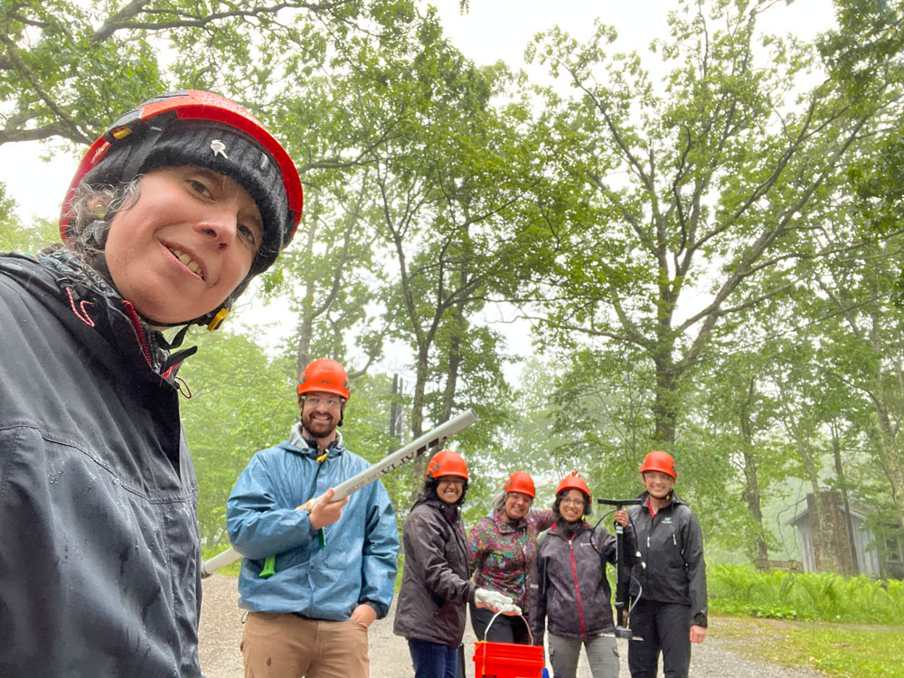 Natalia L. Quinteros Casaverde and SPEC School participants brave the rain to collect field samples