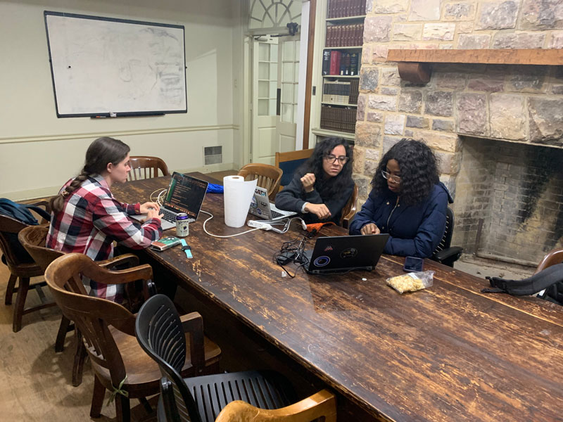 SPEC School participants Kathryn Wheeler, Isamar Cortès, and Yetunde Rotimi work to remotely access NEON data from the Lewis Hall library at MLBS