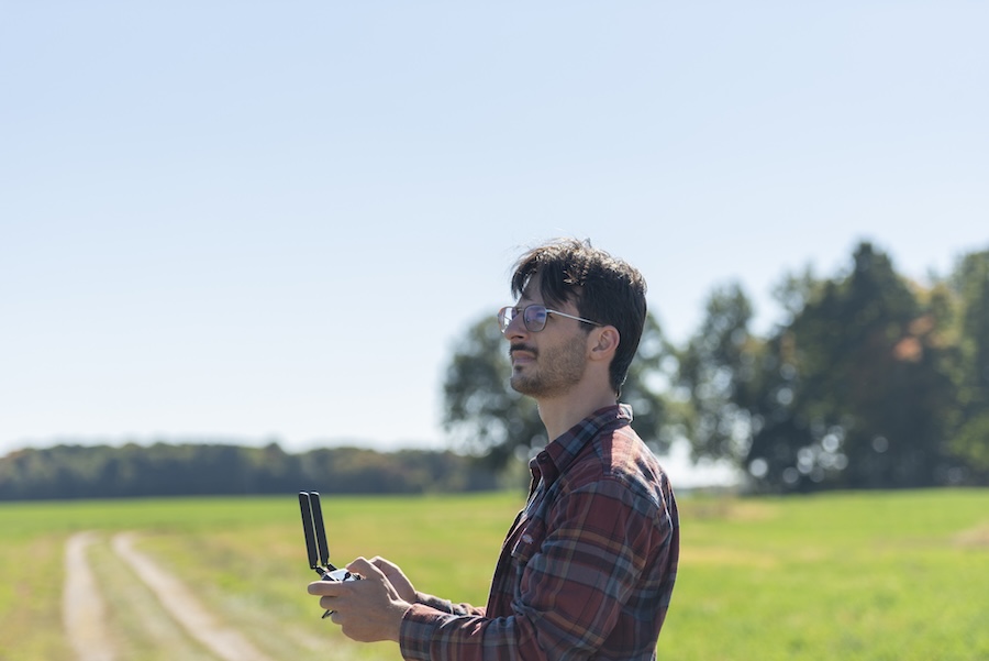 Leo Baldiga flying a drone on the campus of Michigan State University