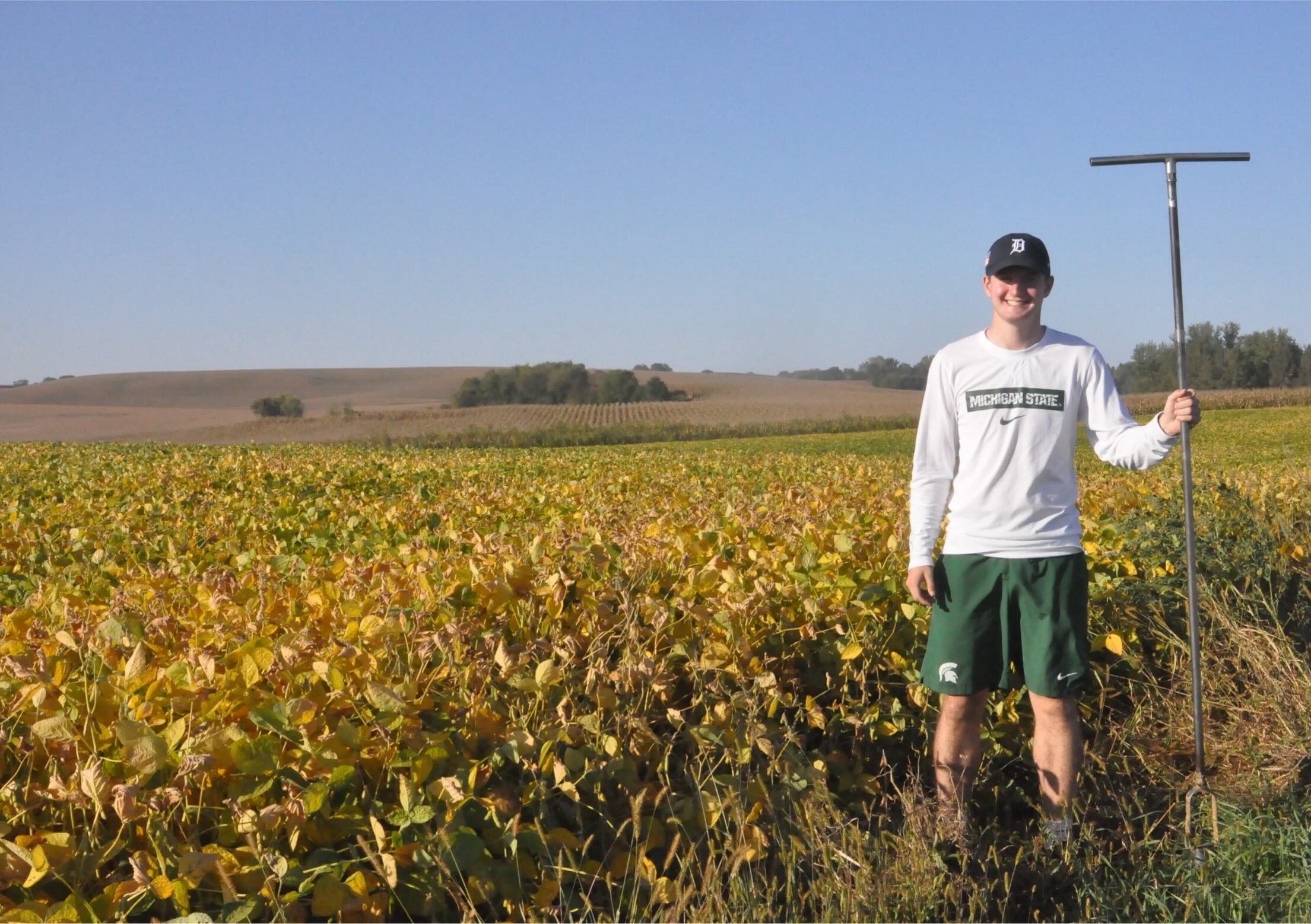 David Pruder with a large auger in a field. 