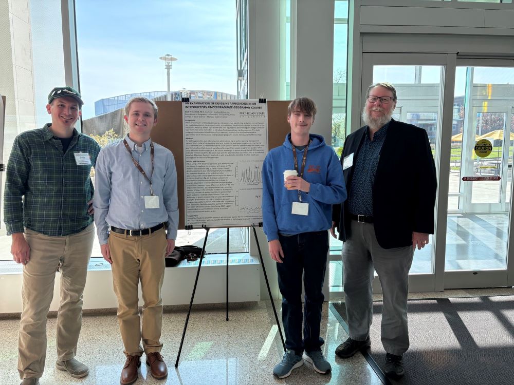 William Romanyk (second from left) presenting at AAG East Lakes/West Lakes meeting in 2024. 