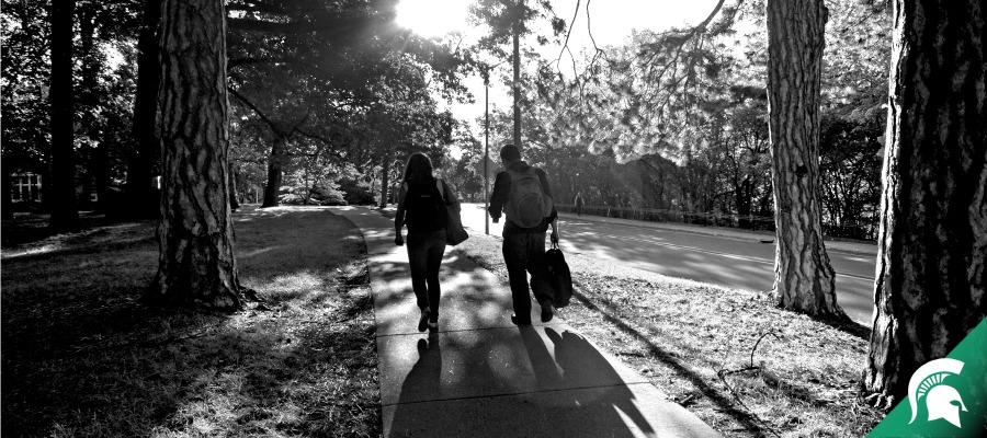 Students walking on campus sidwalk
